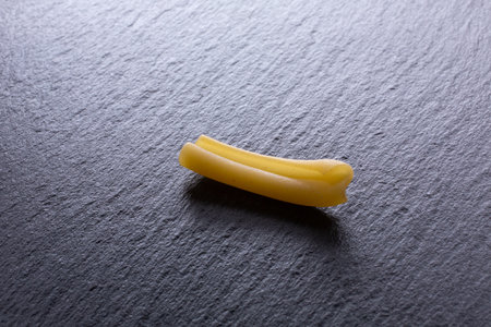 Raw pasta on a slate black background. Selective focus. Toned.の写真素材
