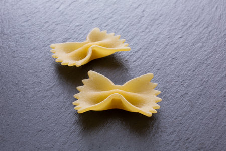 Farfalle pasta on a black background. Selective focus.の写真素材