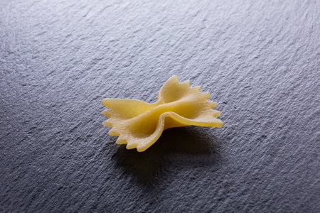 Farfalle pasta on a black background. Selective focus.の写真素材