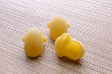 Close up of uncooked italian pasta on wooden table background.の写真素材