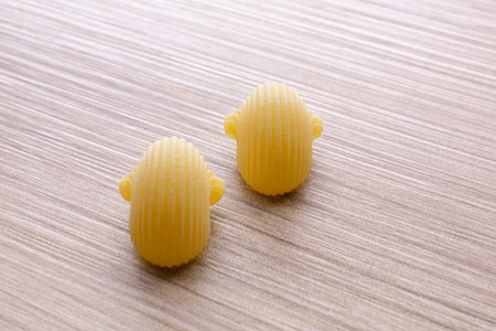 two uncooked pasta on a wooden background, close-up.の写真素材