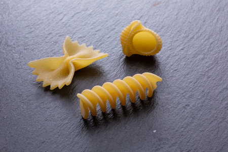 Different types of Italian pasta on a dark background. Selective focus.の写真素材