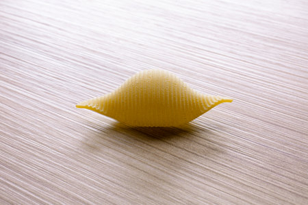 Pasta on a wooden background. Selective focus. Toned.の写真素材