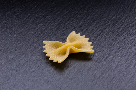 Raw farfalle pasta on black slate background. Top view.の写真素材