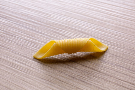 Close up of uncooked italian pasta on a wooden table.の写真素材
