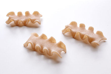 Farfalle pasta on a white background, closeup of photo