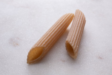 close up of a penne pasta on a white backgroundの写真素材