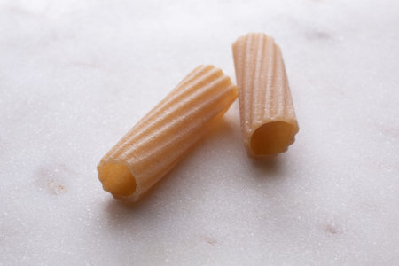 Close-up of italian pasta on white marble background. Whole background.