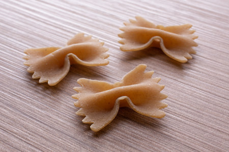Farfalle pasta on wooden background. Italian food. close up.の写真素材