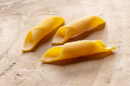 close up of a raw italian pasta on wooden background with copy spaceの写真素材