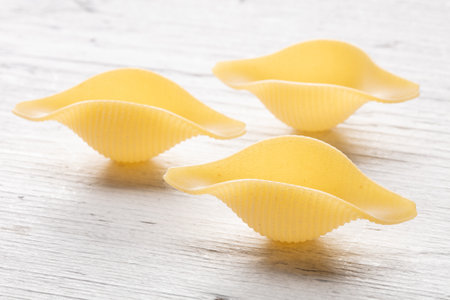 Pasta shells on white wooden background, close upの写真素材
