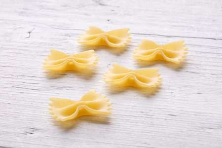 Farfalle pasta on a white wooden background. Top view.の写真素材