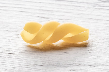 durum wheat pasta macaroni on white wooden backgroundの写真素材