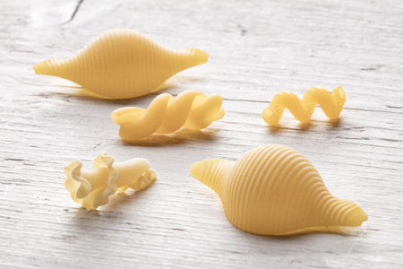 Pasta shells on white wooden background, top view, close upの写真素材