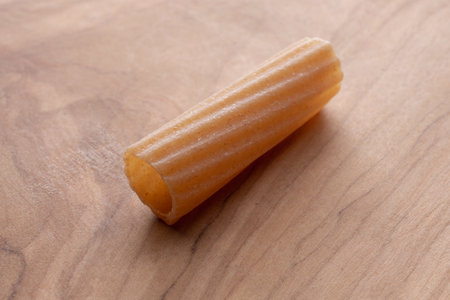 Uncooked italian pasta on wooden background. Close up.の写真素材