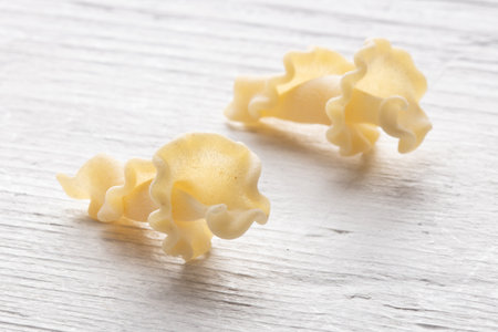close up of a uncooked italian pasta on white wooden backgroundの写真素材