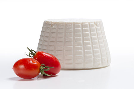 Ricotta cheese with red tomatoes on a white background. Isolatedの写真素材