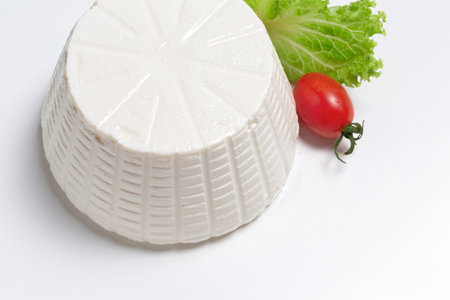 soft ricotta cheese served with salad and tomato on white background top viewの写真素材