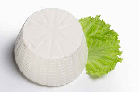 ricotta cheese with lettuce leaf on a white background. High point of viewの写真素材