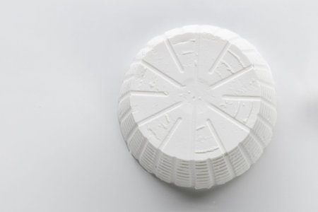 White cheese on a white background. Shallow depth of field.