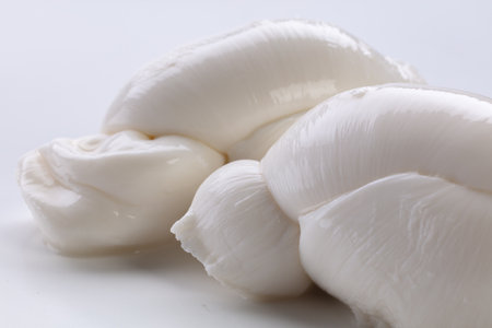 Close-up of fresh mozzarella cheese on white background.の写真素材