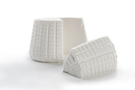 cottage ricotta cheese cut on a white backgroundの写真素材