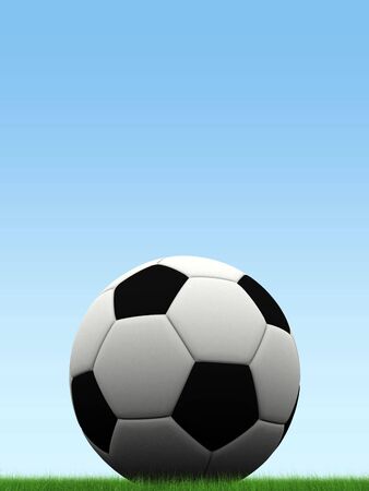 soccer ball on simple blue gradient, resting on grassの写真素材