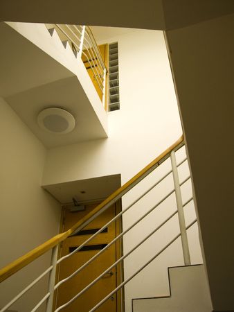 A modern stairwell with wooden bannisterの写真素材