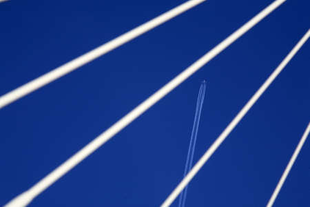 bridge with plane vapourの写真素材