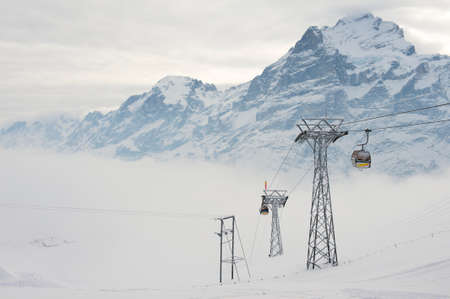 Grindelwald, Switzerland - March 07, 2009: Cable car gondolas move skiers uphill at the ski resort in Grindelwald, Switzerland.のeditorial素材