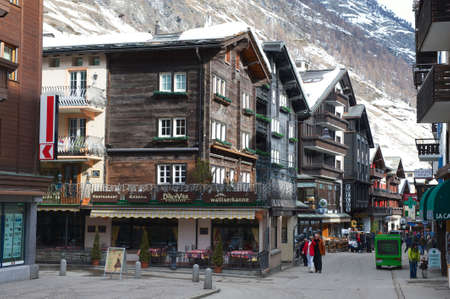 Zermatt, Switzerland, March 04, 2009 - Tourists explore traditional wooden houses street in Zermatt. Zermatt is one of the most popular ski resorts in Switzerland.のeditorial素材