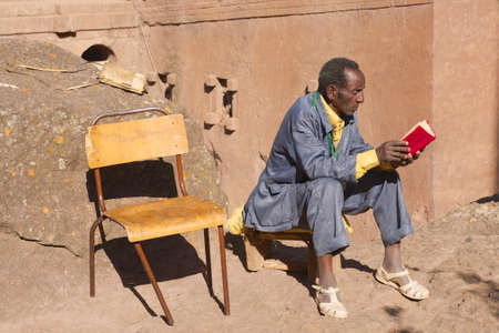 Lalibela, Ethiopia, January 27, 2010 - Man reads book in Lalibela, Ethiopia. Ethiopia has one of the highest levels of illiteracy in the world.のeditorial素材
