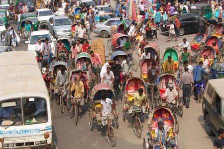 Dhaka, Bangladesh, February 22, 2014 - Rickshaws transport passengers in Dhaka, Bangladesh. About 500 000 rickshaws daily cycle in Dhaka,  nicknamed \\\\\\\"the rickshaws capital of the world\\\\\\\".のeditorial素材