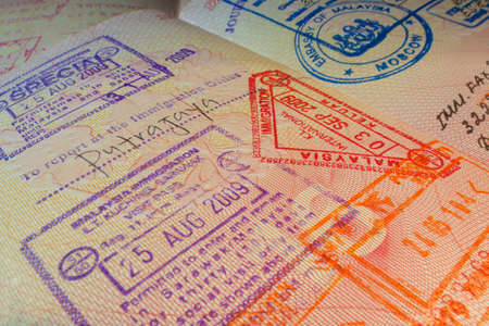 Passport page with Malaysian visa and immigration control stamps.のeditorial素材