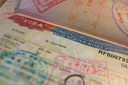Passport page with Korean visa and immigration control stamps.のeditorial素材