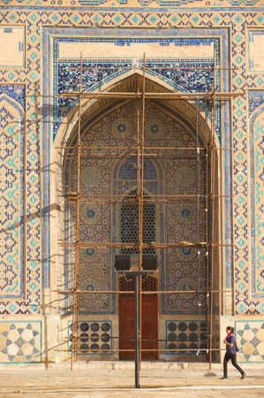 Turkistan, Kazakhstan,  September 20, 2011 - Woman walks around the medieval mausoleum of Khoja Ahmed Yasavi in Turkistan, Kazakhstan. UNESCO World Heritage site.のeditorial素材