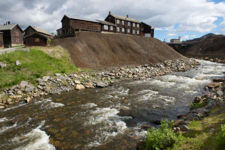 Traditional timber buildings of the copper smelter factory at the bank of Roa river in copper mines town of Roros, Norway. の写真素材