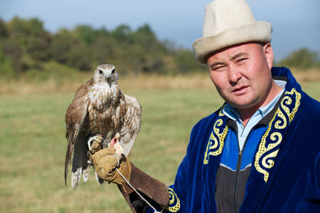 Circa Almaty, Kazakhstan, September 18, 2011 - Man holds falcon circa Almaty, Kazakhstan. Price of trained for hunting falcon from Kazakhstan can reach hundreds of thousands USD for clients from Arab countries.のeditorial素材