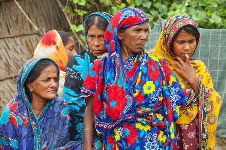 Mongla, Bangladesh, February 17, 2014 - Women wait for their men from fishing in Mongla, Bangladesh.のeditorial素材