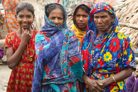 Mongla, Bangladesh, February 17, 2014 - Women wait for their men from fishing in Mongla, Bangladesh.のeditorial素材