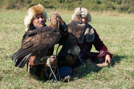 Almaty, Kazakhstan, September 18, 2011 - Men hold golden eagles (Aquila chrysaetos), Almaty, Kazakhstan.のeditorial素材