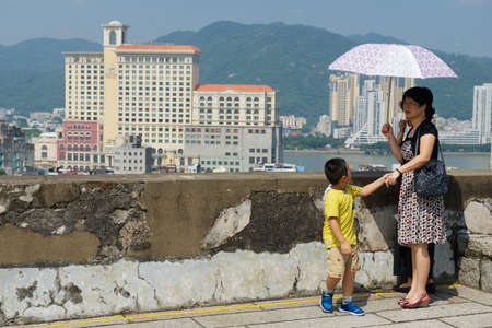 Macau, China, September 11, 2013 - People enjoy the view to downtown Macau, China.のeditorial素材