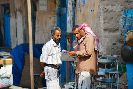 Sanaa, Yemen, September 16, 2006 - Men read newspaper at the street in Sanaa, Yemen.のeditorial素材