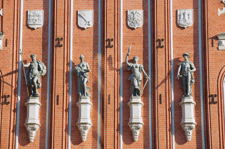 Exterior wall of the House of Blackheads with statues and coats of arms in Riga, Latvia.
