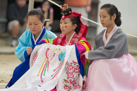 Yongin, Korea, September 02, 2008 - Women demonstrate traditional Korean wedding dress in Yongin, Korea.のeditorial素材