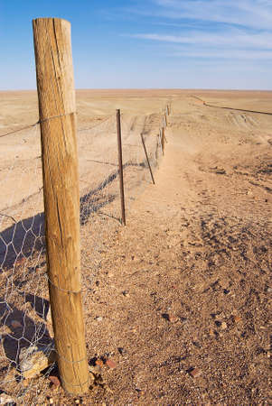 Dingoe fence in the Australian Outback. The fence is 9600 kilometers long, it keeps the dingoe dogs out of the areas, where the sheep graze.の写真素材