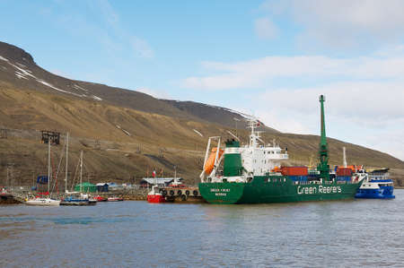 Longyearbyen Norway September March 2011: Cargo ship unloads at the harbor of Longyearbyen in Longyearbyen Norway.のeditorial素材