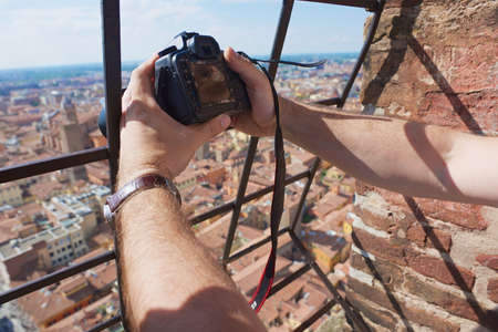 Bologna Italy May November 2013 Tourist makes a travel photo from the top of Asinelli tower in Bologna Italy.のeditorial素材