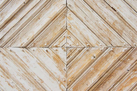 Rhomb pattern of the old weathered white-painted wooden gate.の写真素材