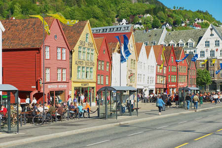 Bergen, Norway, June 06, 2010 - People walk by Bryggen in Bergen, Norway. Bryggen is a UNESCO world Heritge site.のeditorial素材